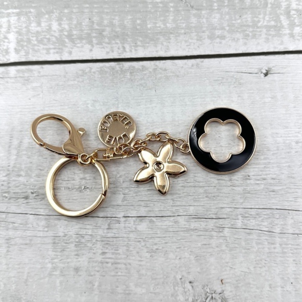 Unbranded keychain or purse charm. Gold and black. NEW.